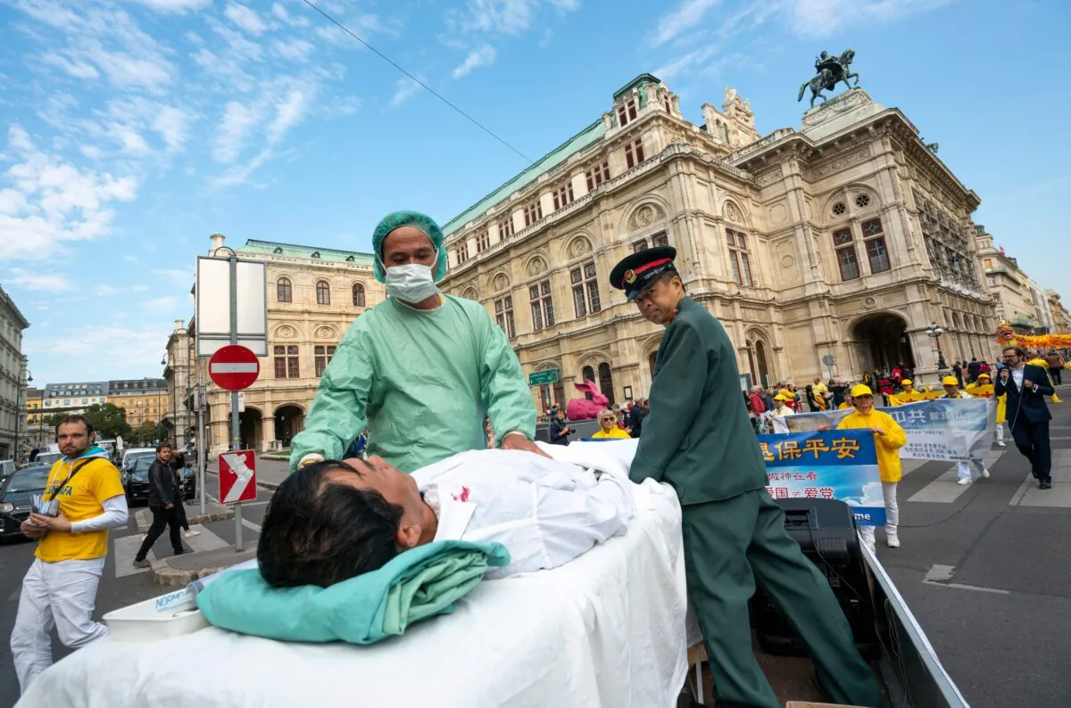 Falun Gong practitioners stage a reenactment of organ harvesting from imprisoned practitioners in China, during a protest in Vienna on Oct. 1, 2018. (Joe Klamar/AFP via Getty Images)