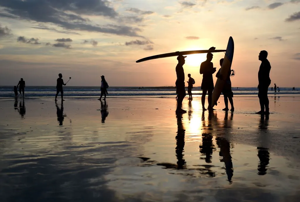 Balinese surfers hold their sufboards during sunset at Kuta beach near Denpasar, on Indonesia's resort island of Bali on May 13, 2017. (Sonny Tumbelaka/AFP via Getty Images)