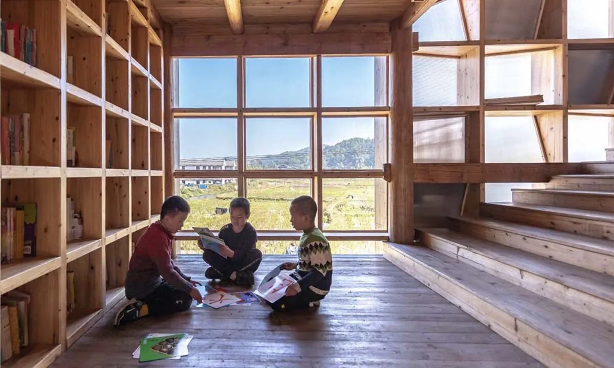 Children sit inside the 'Pingtan Children’s library' designed and built by the School of Architecture of the CUHK in a Dong minority village, Pingtan township, Hunan province, China in an undated photo. (Courtesy of CUHK)