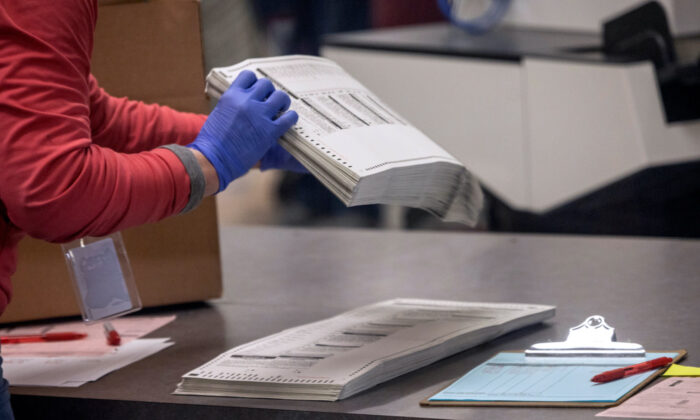 An election worker sorts ballots in a file photo. (John Moore/Getty Images)