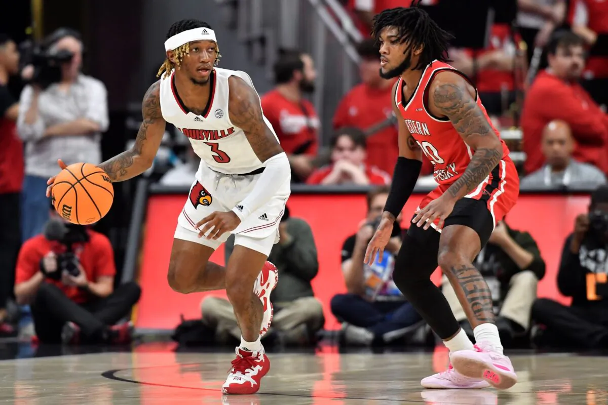 Louisville guard El Ellis (3) moves the ball around Western Kentucky guard Dayvion McKnight (20) during the first half of an NCAA college basketball game in Louisville, Ky., on Dec. 14, 2022. (Timothy D. Easley/AP Photo)