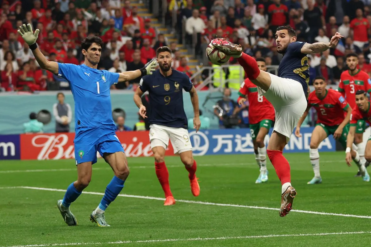 French defender (22) Theo Hernandez strikes the ball to score his team's first goal past Morocco's goalkeeper (1) Yassine Bounou during the Qatar 2022 World Cup semi-final football match between France and Morocco at the Al-Bayt Stadium in Al Khor, on Dec. 14, 2022. (Adrian Dennic/AFP via Getty Images)