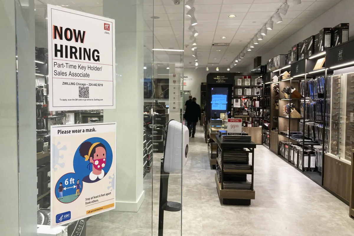 A hiring sign at a kitchen supply store in Rosemont, Ill., on Dec. 13, 2022. (Nam Y. Huh/AP Photo)