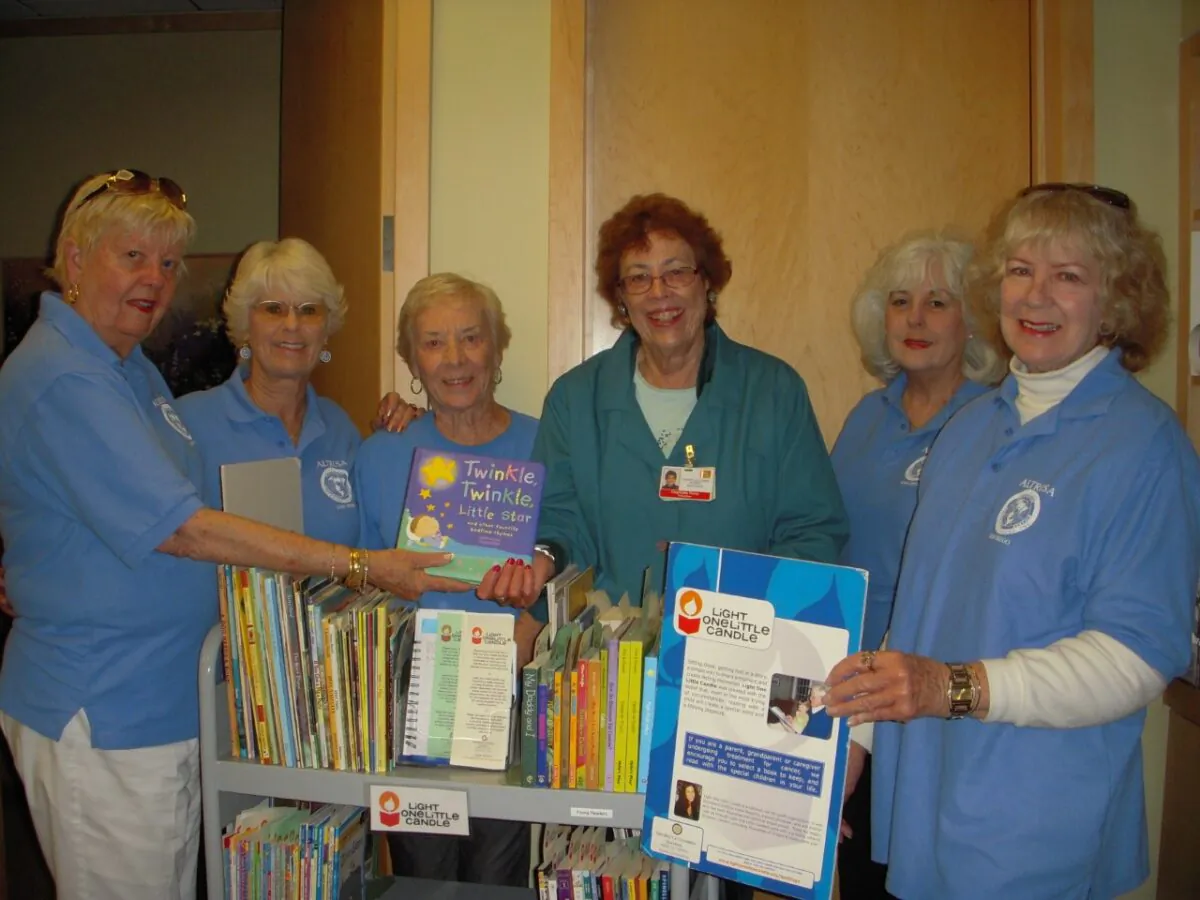 Charlotte Perry (C) and volunteers from Altrusa International Inc, of San Diego, deliver books to Moore’s Cancer Center in La Jolla, Calif. (Courtesy of Charlotte Perry)