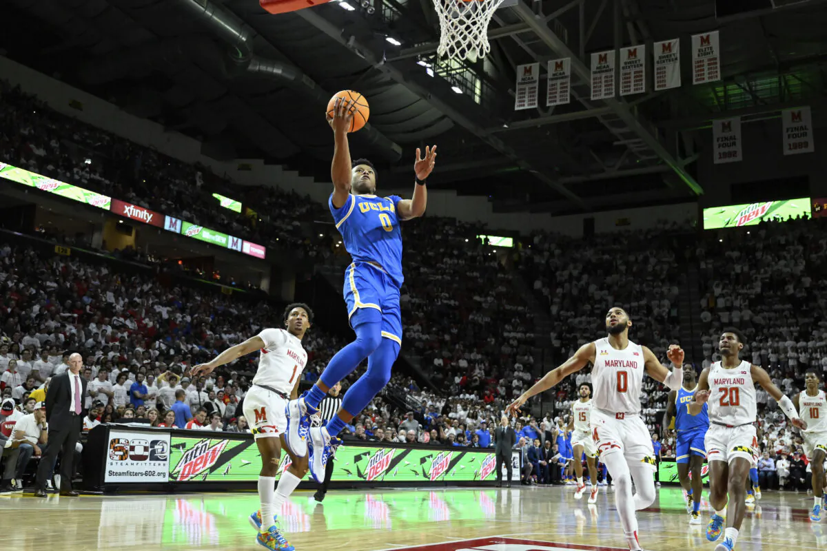 UCLA guard Jaylen Clark (0) goes to the basket for lay up and is fouled by Maryland guard Jahmir Young (1) during the first half of an NCAA college basketball game,  in College Park, Md., on Dec. 14, 2022. (Terrance Williams/AP Photo)