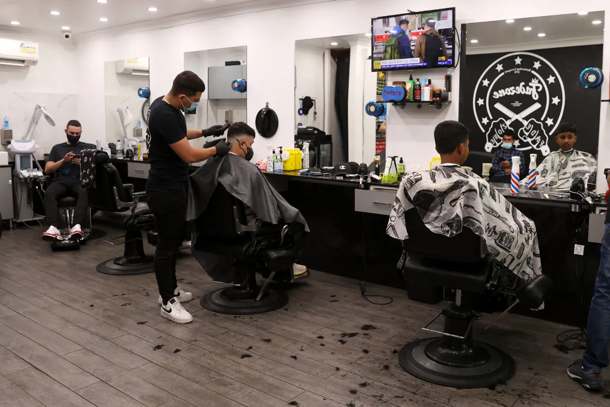 The staff of Fadezone barber shop are seen cutting hair in Sydney, Australia, on Oct. 11, 2021. (Mark Kolbe/Getty Images)
