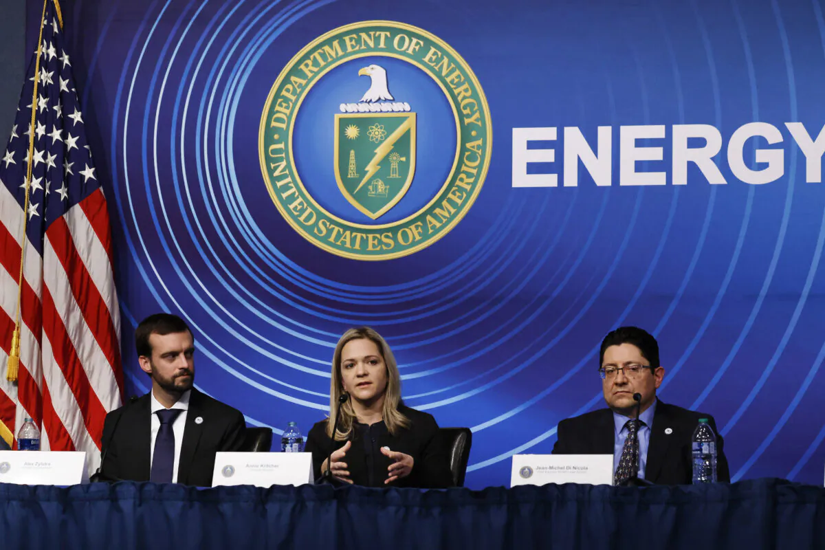 Scientists from the Lawrence Livermore National Laboratories (L-R) Principal Experimentalist Alex Zylstra, Principal Designer Annie Kritcher, and Chief Engineer for National Ignition Facility Laser System Jean-Michel Di Nicola hold a news conference at the Department of Energy headquarters to announce a breakthrough in fusion research in Washington, on Dec. 13, 2022. (Chip Somodevilla/Getty Images)