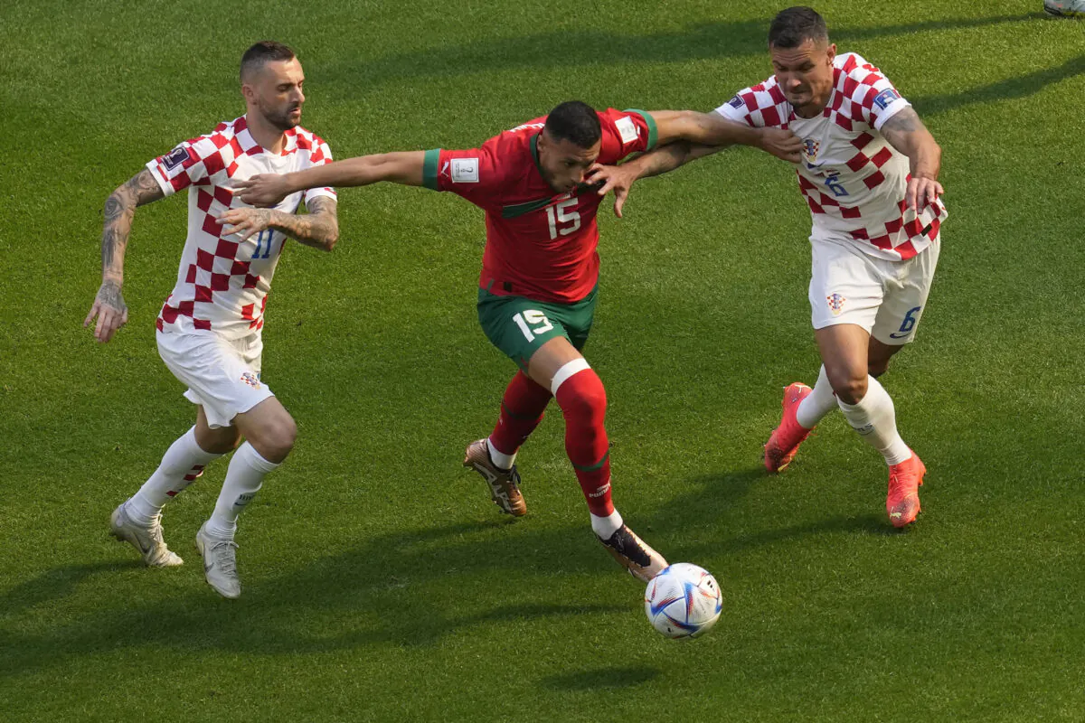 Croatia's Marcelo Brozovic, left, Morocco's Selim Amallah, Croatia's Dejan Lovren, vie for the ball during the World Cup group F soccer match between Morocco and Croatia at the Al Bayt Stadium in Al Khor, Qatar, on Nov. 23, 2022. (Darko Vojinovic/AP Photo)