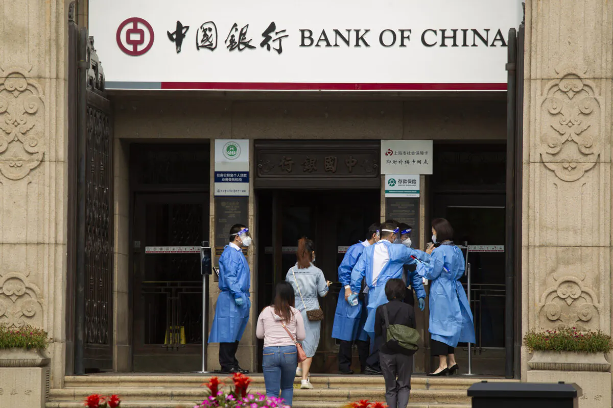 Staff enter a bank at the Bund historical area on June 01, 2022 in Shanghai, China. (Hu Chengwei/Getty Images)
