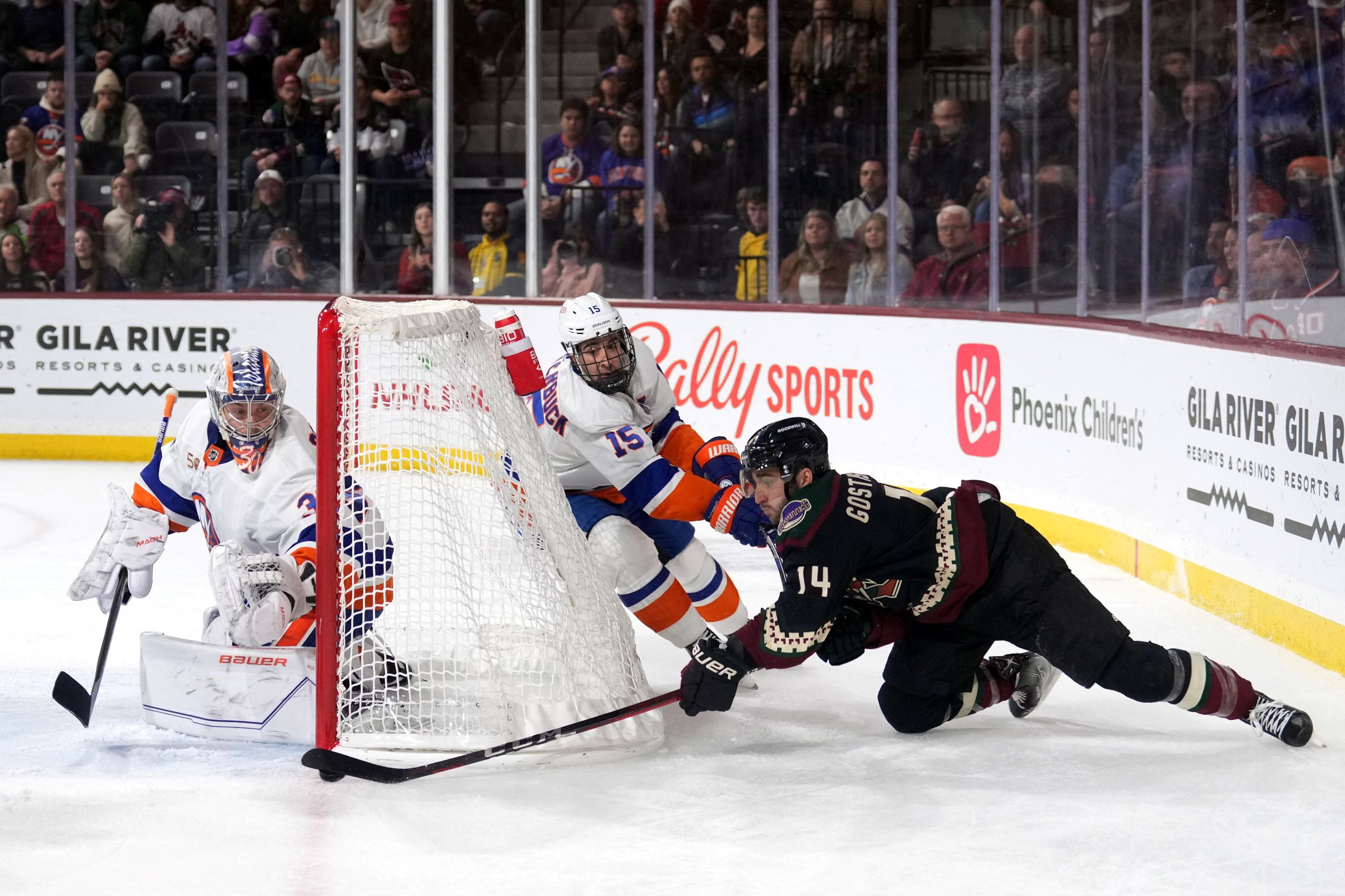 Shayne Gostisbehere (14), and Cal Clutterbuck (15)