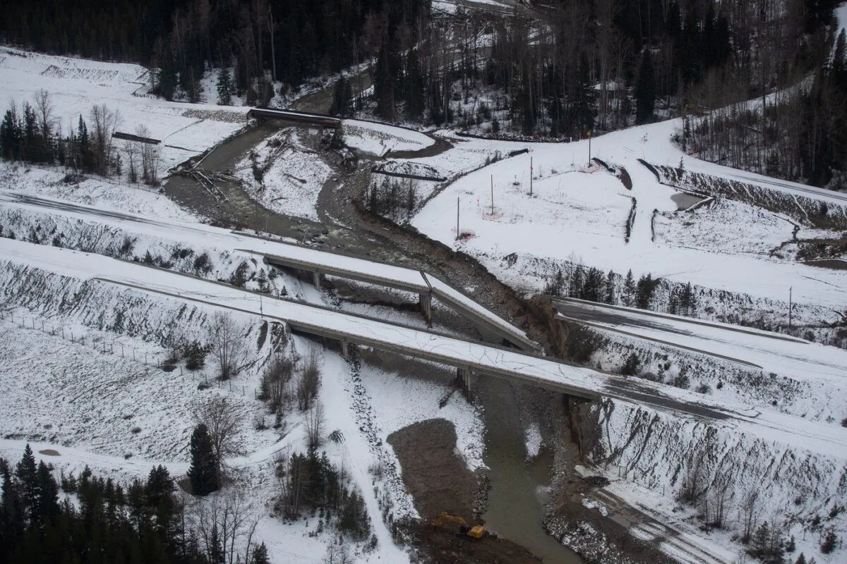 A collapsed section of a bridge sits in the water after severe flooding and landslides on the Coquihalla Highway south of Merritt, B.C., as seen in an aerial view from a Canadian Forces reconnaissance flight on Nov. 22, 2021. (The Canadian Press/Darryl Dyck)