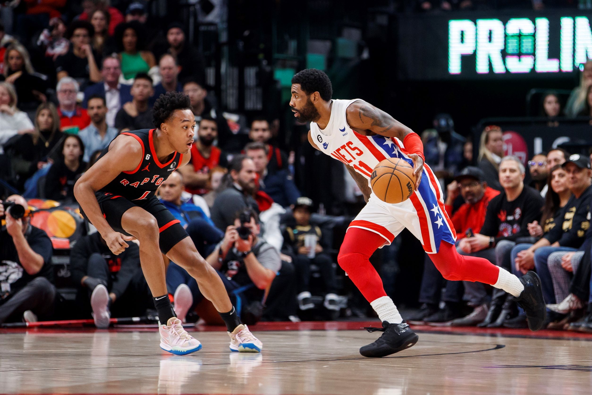 Kyrie Irving (11), and Scottie Barnes (L)