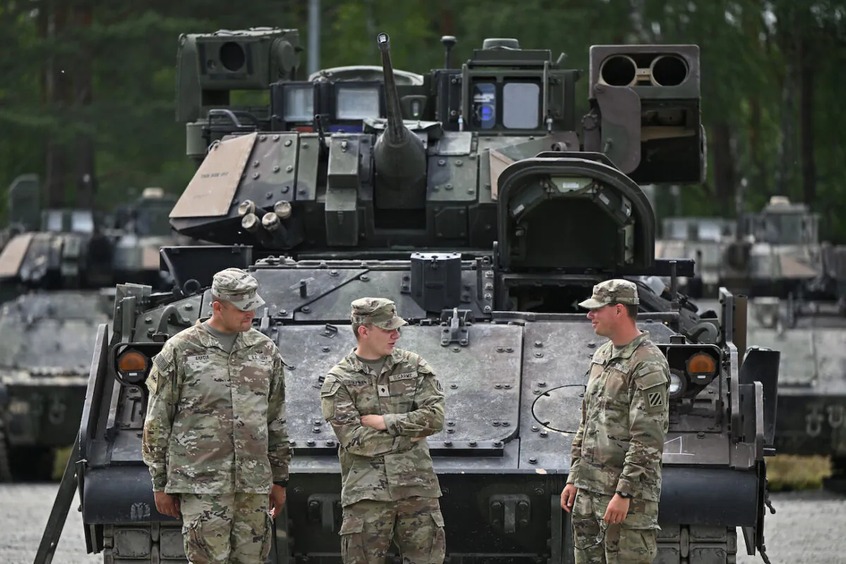 Soldiers of the U.S. Army 1st Raider Brigade stand in front of tanks at the Grafenwoehr training grounds near Grafenwoehr, Germany, on July 13, 2022. (Lennart Preiss/Getty Images)