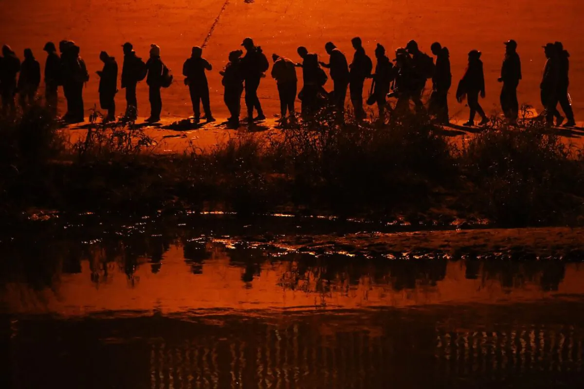 Illegal immigrants traveling in a caravan of more than a thousand people from countries such as Nicaragua, Peru, Ecuador, Colombia, Venezuela, and the Dominican Republic cross the Rio Grande river to ask for political asylum in the United States, in Ciudad Juarez, Chihuahua state, Mexico, on Dec. 11, 2022. (Herika Martinez/AFP via Getty Images)