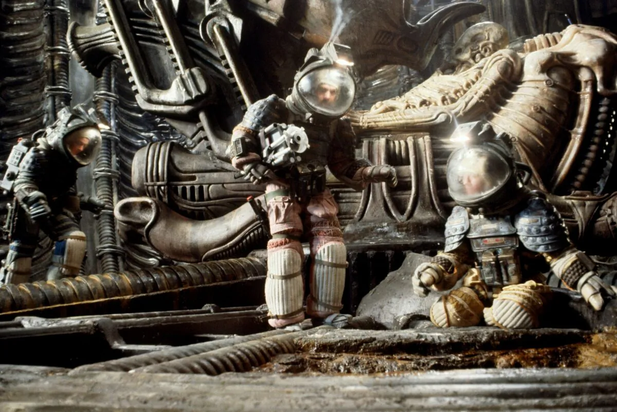 (L–R) Kane (John Hurt), Captain Dallas (Tom Skerritt), and the ship's navigator Lambert (Veronica Cartright) in a scene from "Alien." Its trailer doesn't give away the story. (MovieStillsDB)