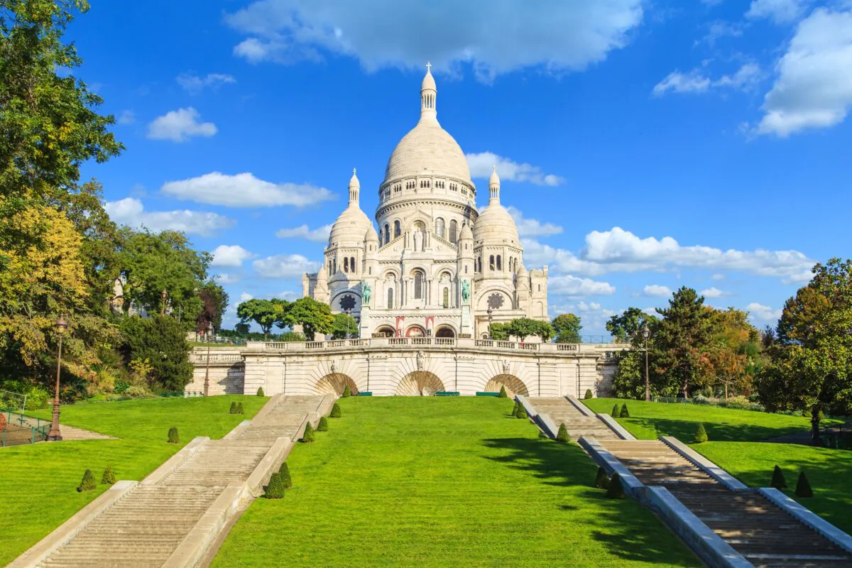 The Sacré-Coeur is located on the butte (a steep, high hill) of Montmartre in the center of Paris. Seen here are two stairways to reach the basilica. Its exterior is particularly impressive for its domes and pristine appearance. The façade consists of travertine stones, also known as Château-Landon, which exude calcite on contact with water, naturally whitening the façade. (Marcin Krzyzak/Shutterstock)