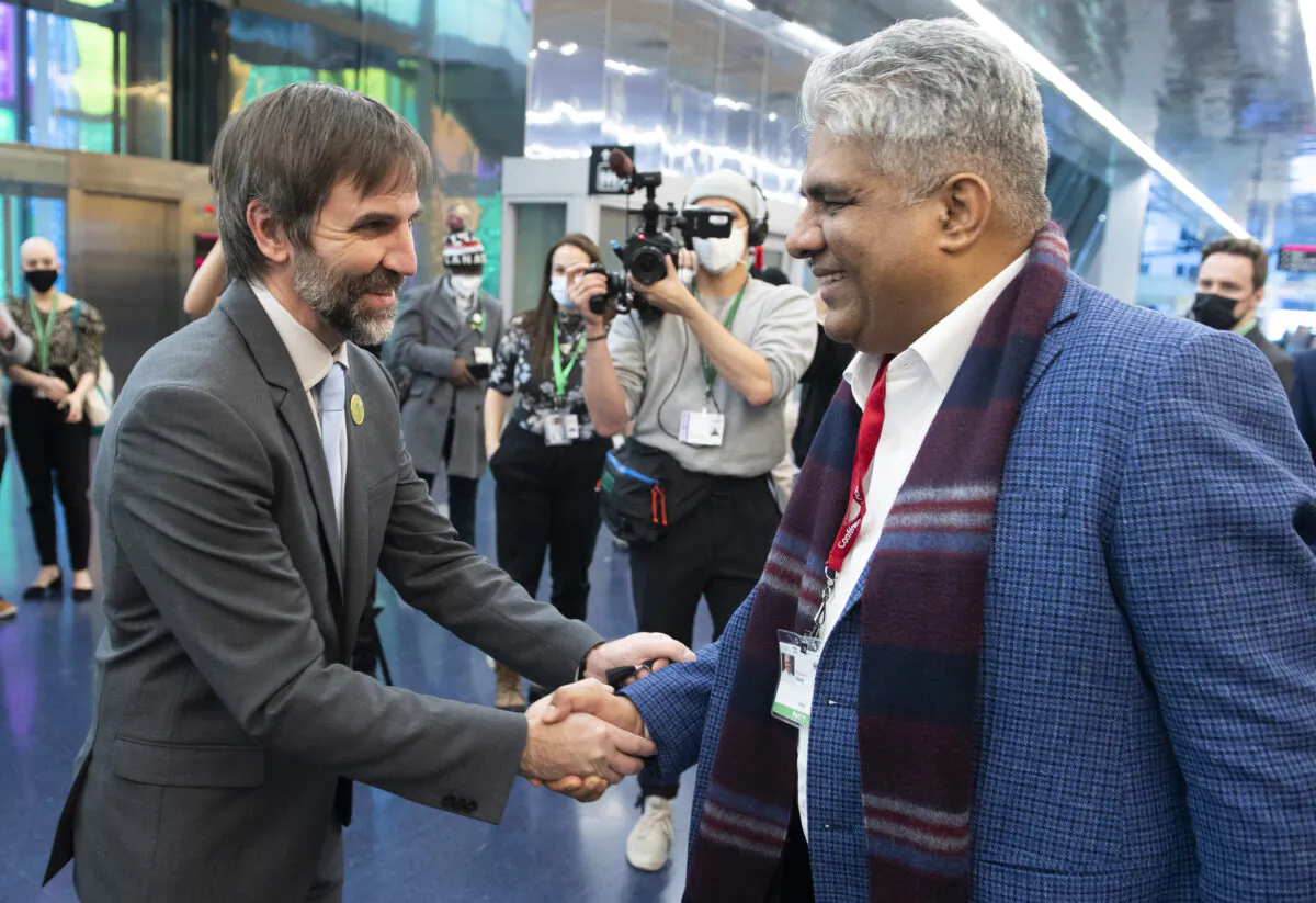 Environment Minister Steven Guilbeault (L) shakes hands with Bhupender Yadav, environment minister of India, at the COP15 UN Biodiversity Conference in Montreal on Dec. 18, 2022. (Graham Hughes/The Canadian Press)