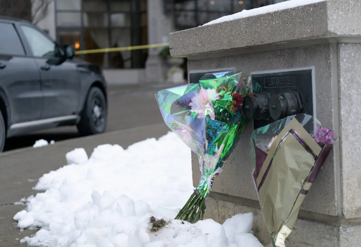 Flowers are left outside a condominium building the day after a shooting in Vaughan, Ont., on Dec, 19, 2022. (The Canadian Press/Arlyn McAdorey)