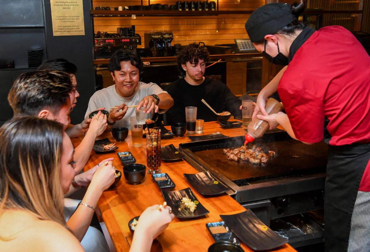 A chef serves food at a Japanese restaurant in Melbourne, Australia, on Oct. 22, 2021. (William West/AFP via Getty Images)