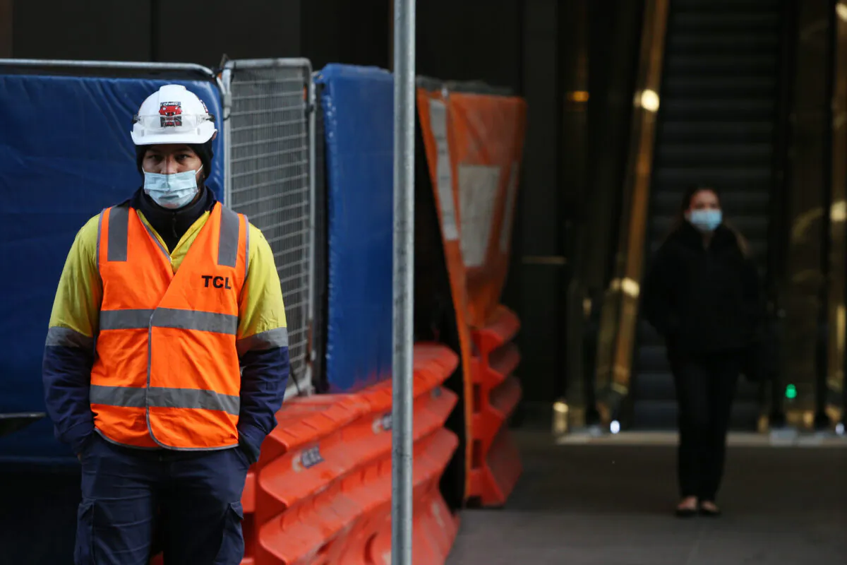 A traffic controller stands outside a worksite along George Street in Sydney, Australia, on June 28, 2021. (Lisa Maree Williams/Getty Images)