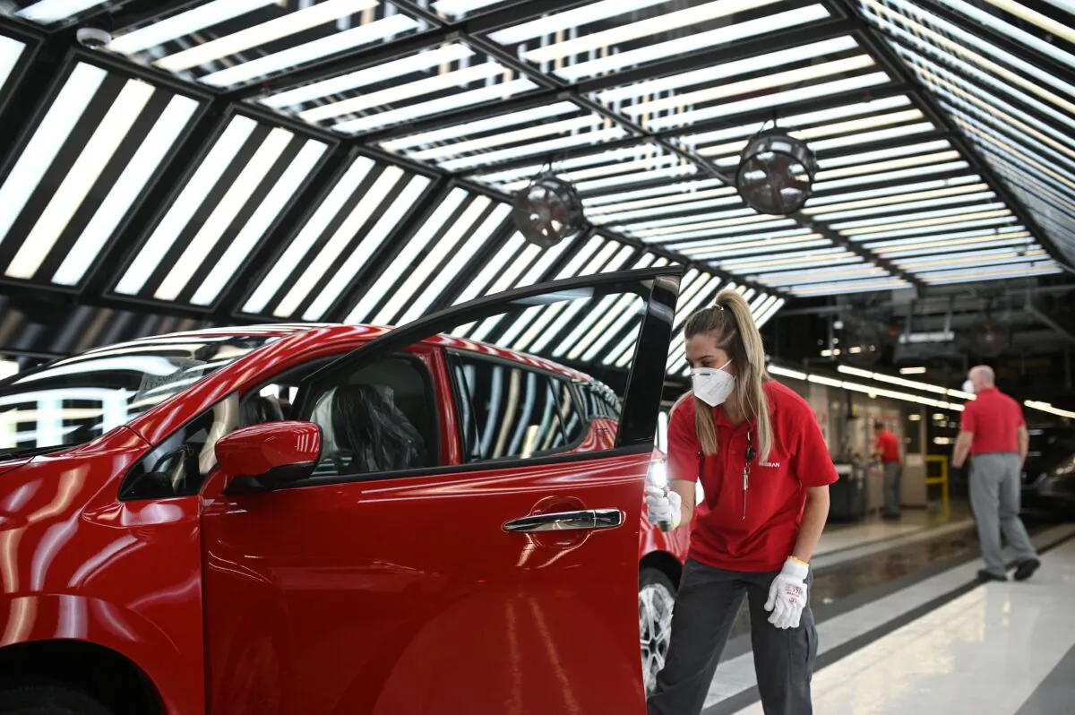 Nissan employees make final checks to cars on the production line at Nissan's plant in Sunderland, northeast England, on July 1, 2021. (Oli Scarff/AFP via Getty Images)