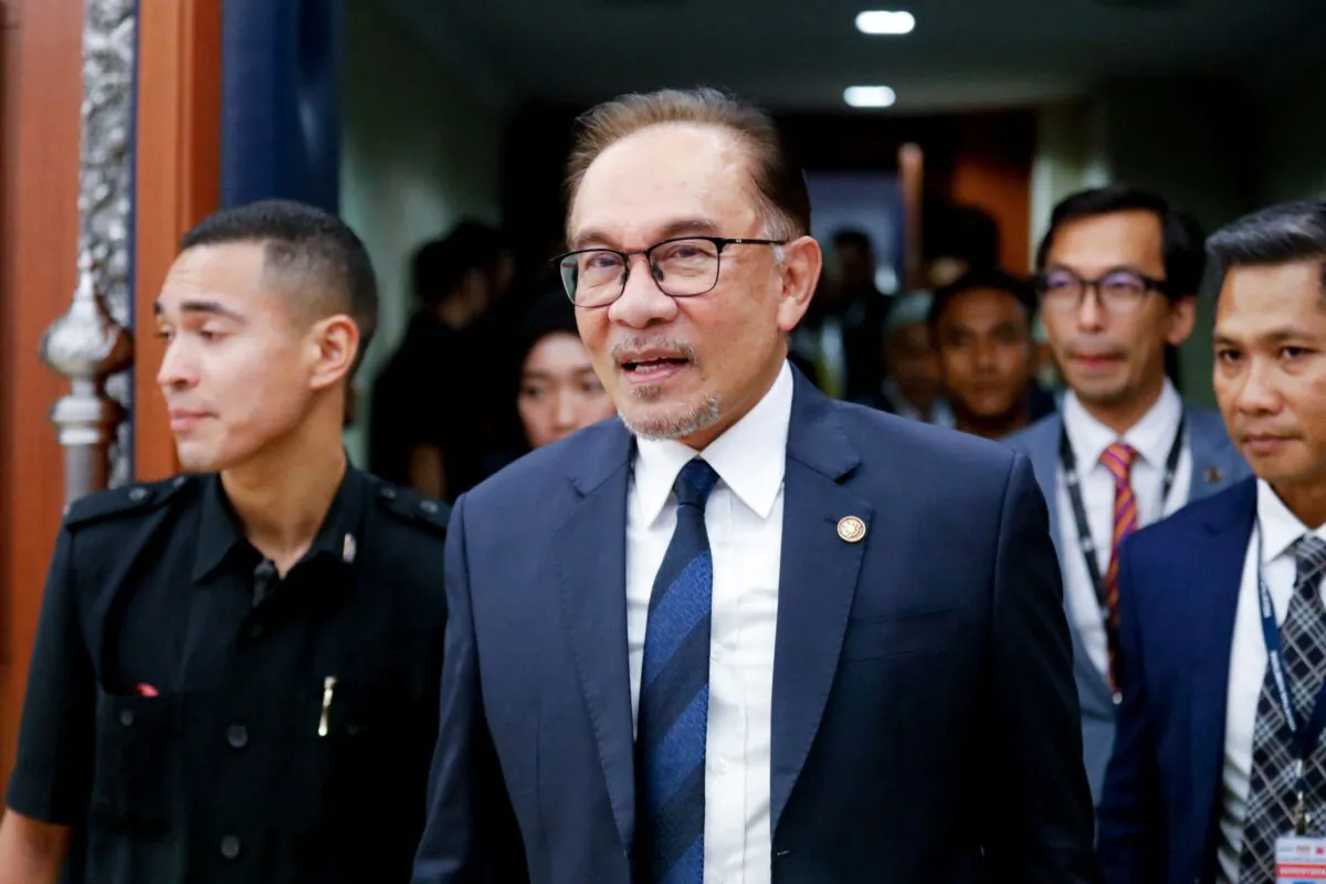 Malaysian Prime Minister Anwar Ibrahim leaves the lower house of Parliament after receiving a vote of confidence, in Kuala Lumpur on Dec. 19, 2022. (Photo by Hasnoor Hussain / POOL / AFP via Getty Images)