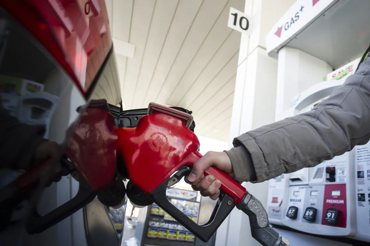 A woman fills up her vehicle with gas in Toronto, on April 1, 2019. (The Canadian Press/Christopher Katsarov)