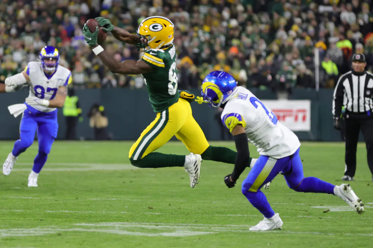 Romeo Doubs (87) of the Green Bay Packers makes a catch over Troy Hill (2) of the Los Angeles Rams at Lambeau Field in Green Bay, Wis., on Dec. 19, 2022. (Stacy Revere/Getty Images)
