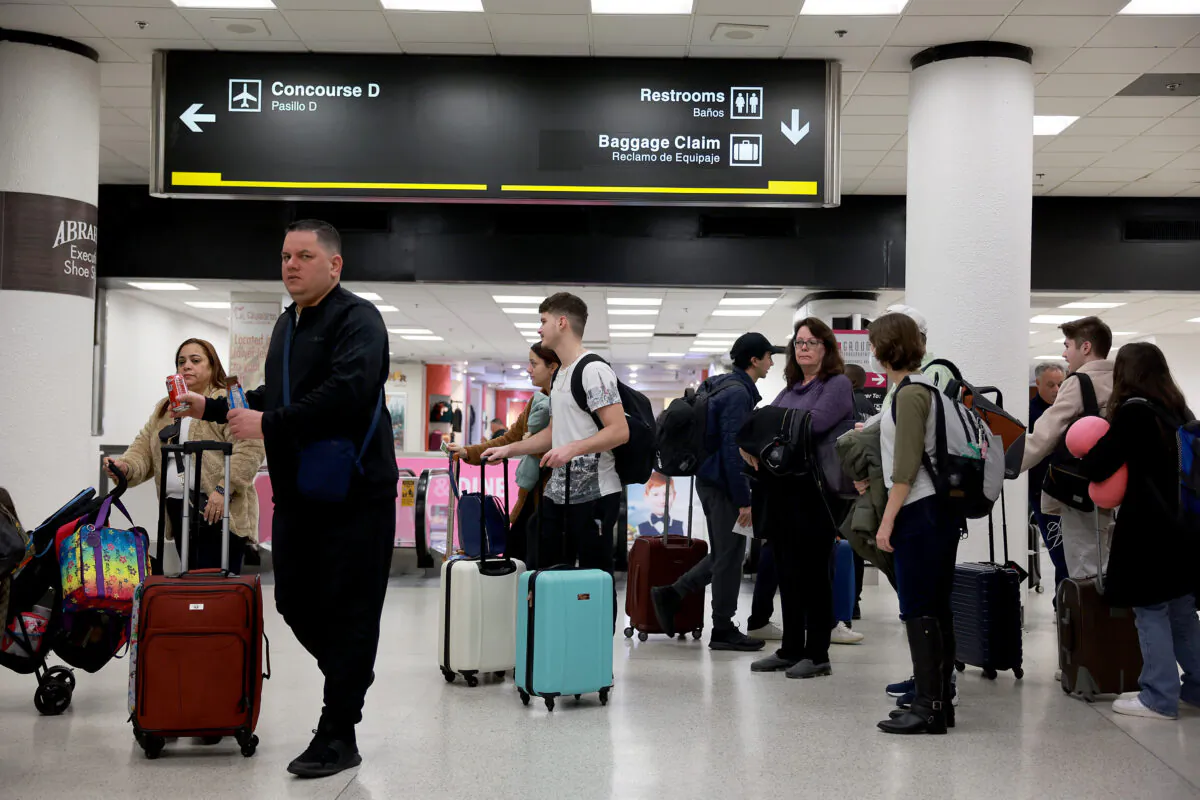 Travelers stand in line for a TSA checkpoint at the Miami International Airport in Miami on Dec. 19, 2022. (Joe Raedle/Getty Images)