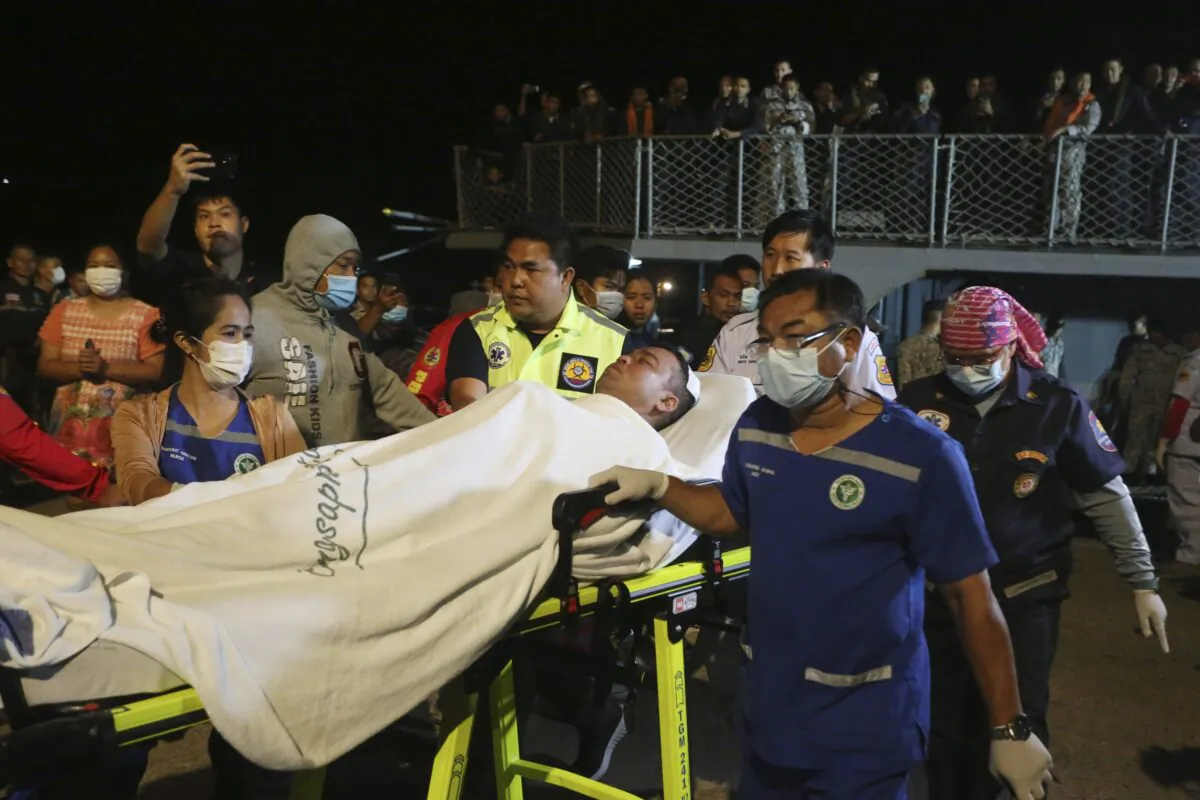 A rescued sailor from HTMS Sukhothai corvette is transferred on land at the Bangsaphan deep port in Prachuap Khiri Khan province, Thailand, on Dec. 19, 2022. (Anuthep Cheysakron/AP Photo)