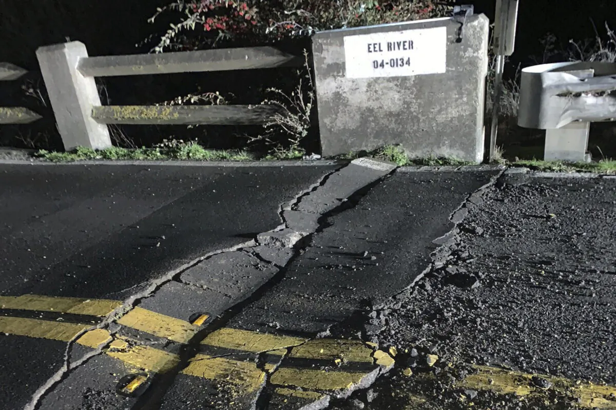 A road closure on California State Route 211 at Fernbridge, a 1,320-foot-long (402.3 m) concrete arch bridge that spans the Eel River near Fortuna, Calif., in Humboldt County. (Caltrans District 1 via AP)