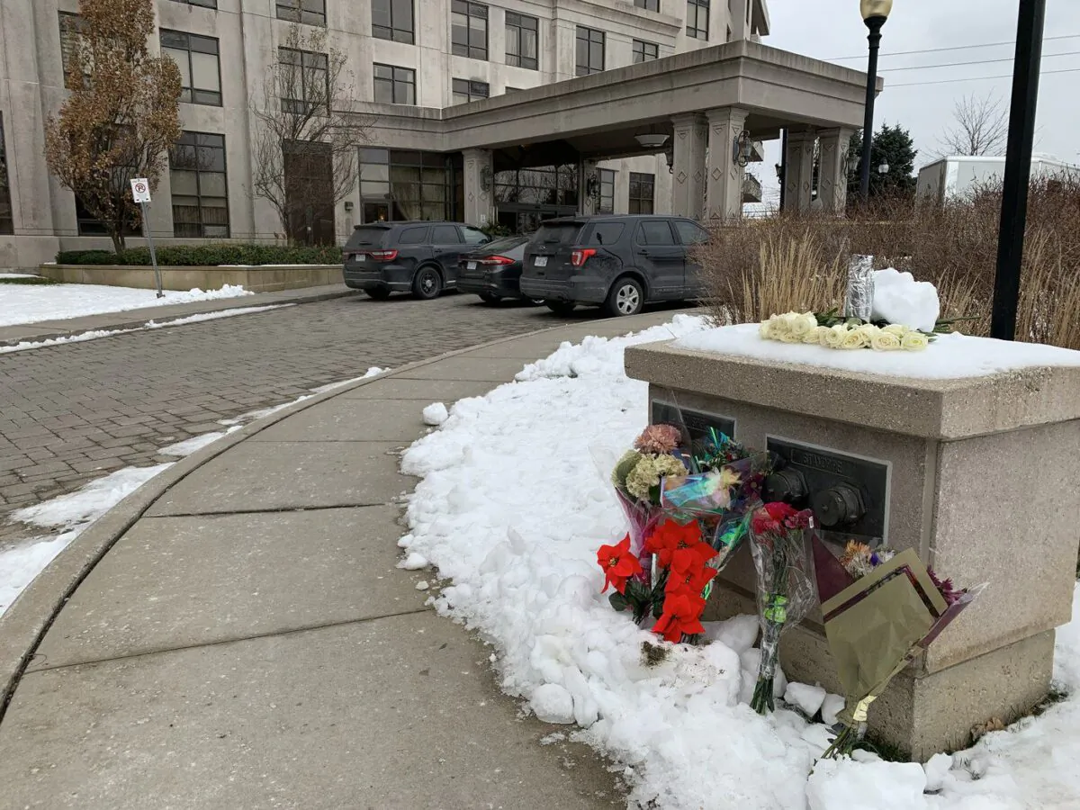 Floral tributes are shown outside a condo building in Vaughan, Ont., Dec. 20, 2022. (Fakiha Baig/The Canadian Press)