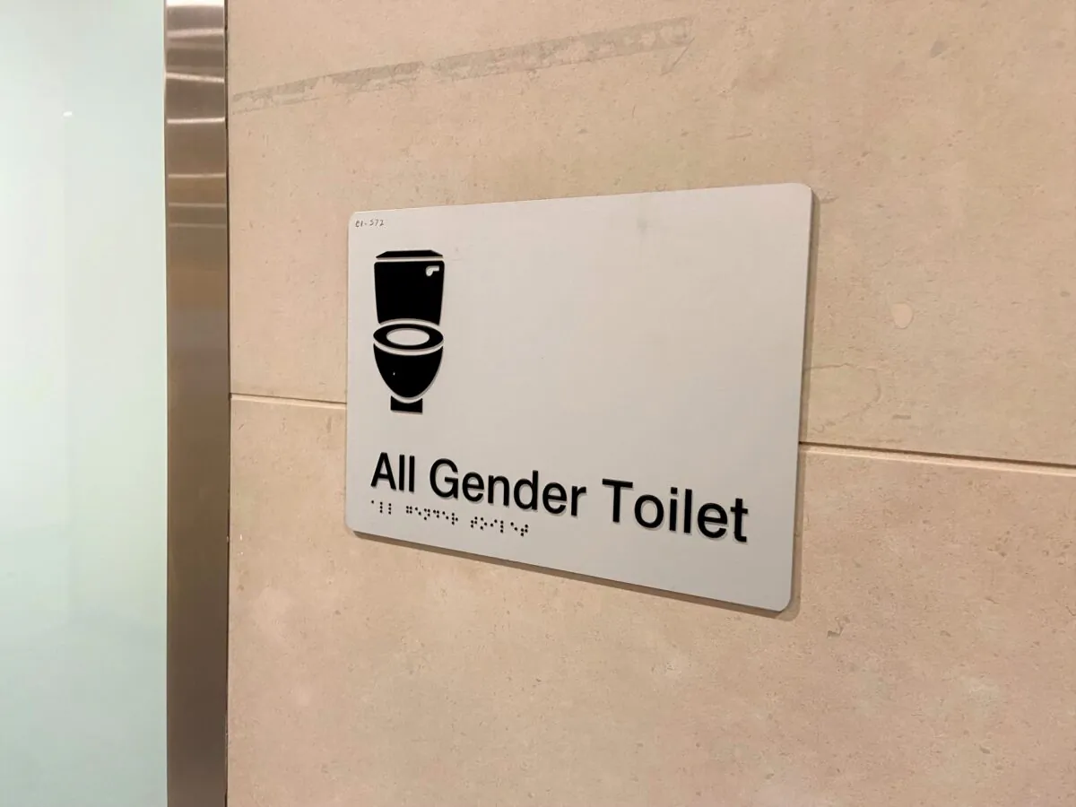 Signage for an 'all gender' bathroom at Sydney's International Airport in Australia on Dec. 11, 2022. (Daniel Teng/The Epoch Times)