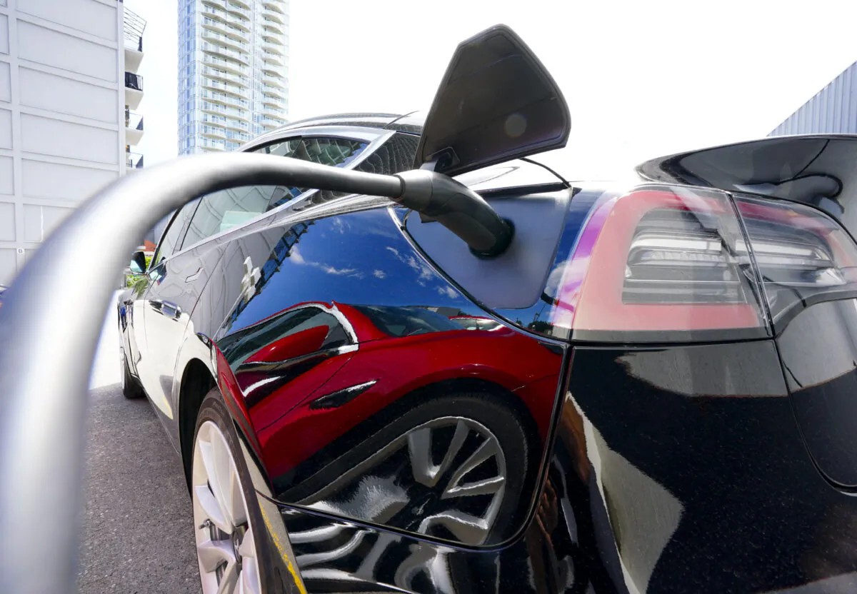 An electric vehicle is charged in Ottawa on July 13, 2022. (Sean Kilpatrick/The Canadian Press)