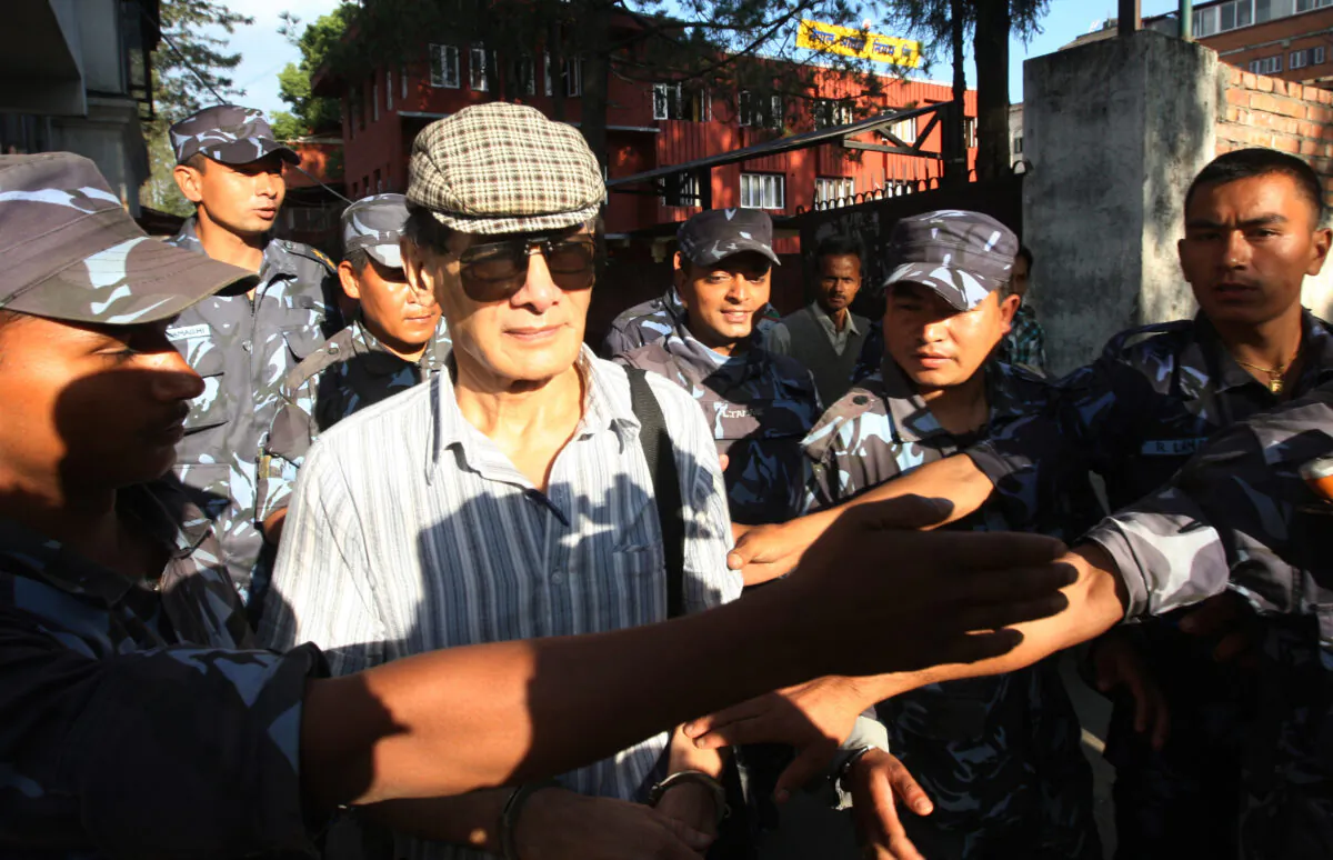 French serial killer Charles Sobhraj (C) is guided by Nepalese policemen towards a waiting vehicle after a court hearing in Kathmandu, Nepal, on May 31, 2011. (Prakash Mathema/AFP via Getty Images)