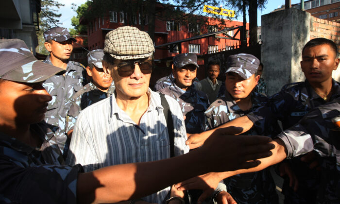 French serial killer Charles Sobhraj (C) is guided by Nepalese policemen towards a waiting vehicle after a court hearing in Kathmandu, Nepal, on May 31, 2011. (Prakash Mathema/AFP via Getty Images)