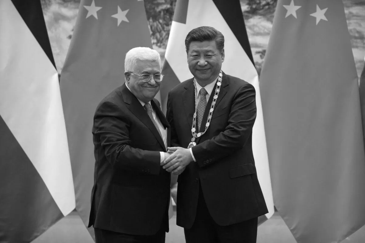 Palestinian President Mahmoud Abbas (L) shakes hands after presenting a medallion to Chinese leader Xi Jinping during a signing ceremony at the Great Hall of the People in Beijing on July 18, 2017. (Mark Schiefelbein/AFP via Getty Images)