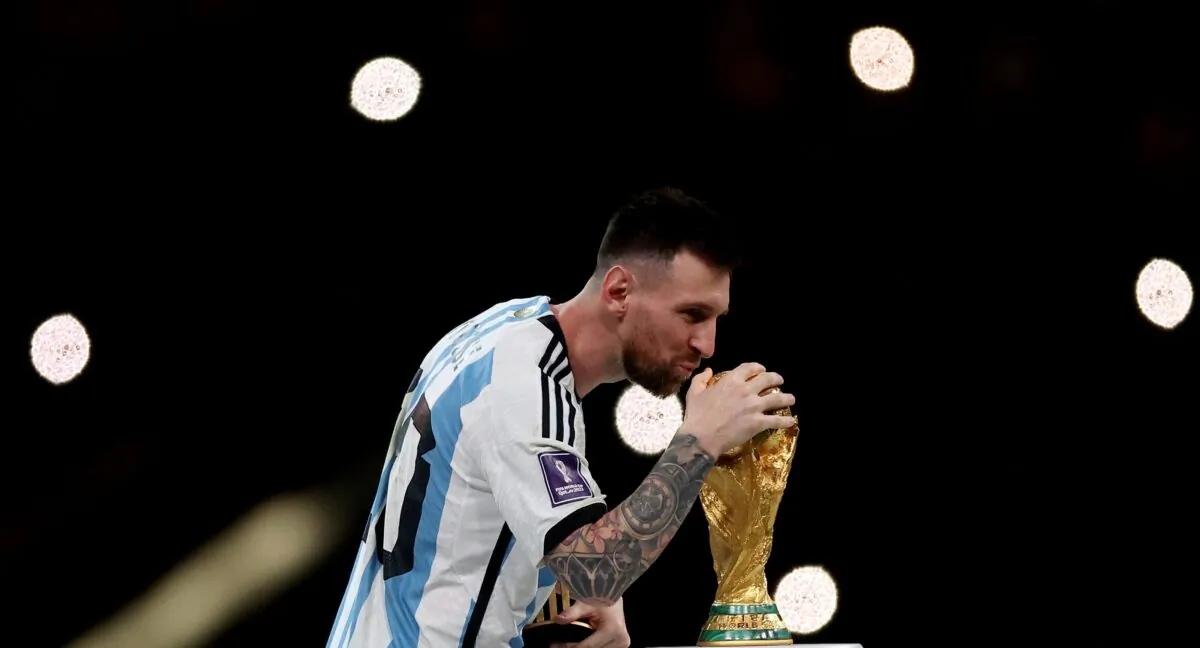 Argentina's Lionel Messi celebrates with the trophy after winning the World Cup, during the match of Argentina v France in Lusail Stadium, Lusail, Qatar on Dec. 18, 2022. (Lee Smith/Reuters)