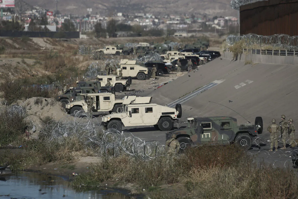 U.S. military guard El Paso's border with Mexico, seen from Ciudad Juarez, Mexico, on Dec. 20, 2022. (AP Photo/Christian Chavez)