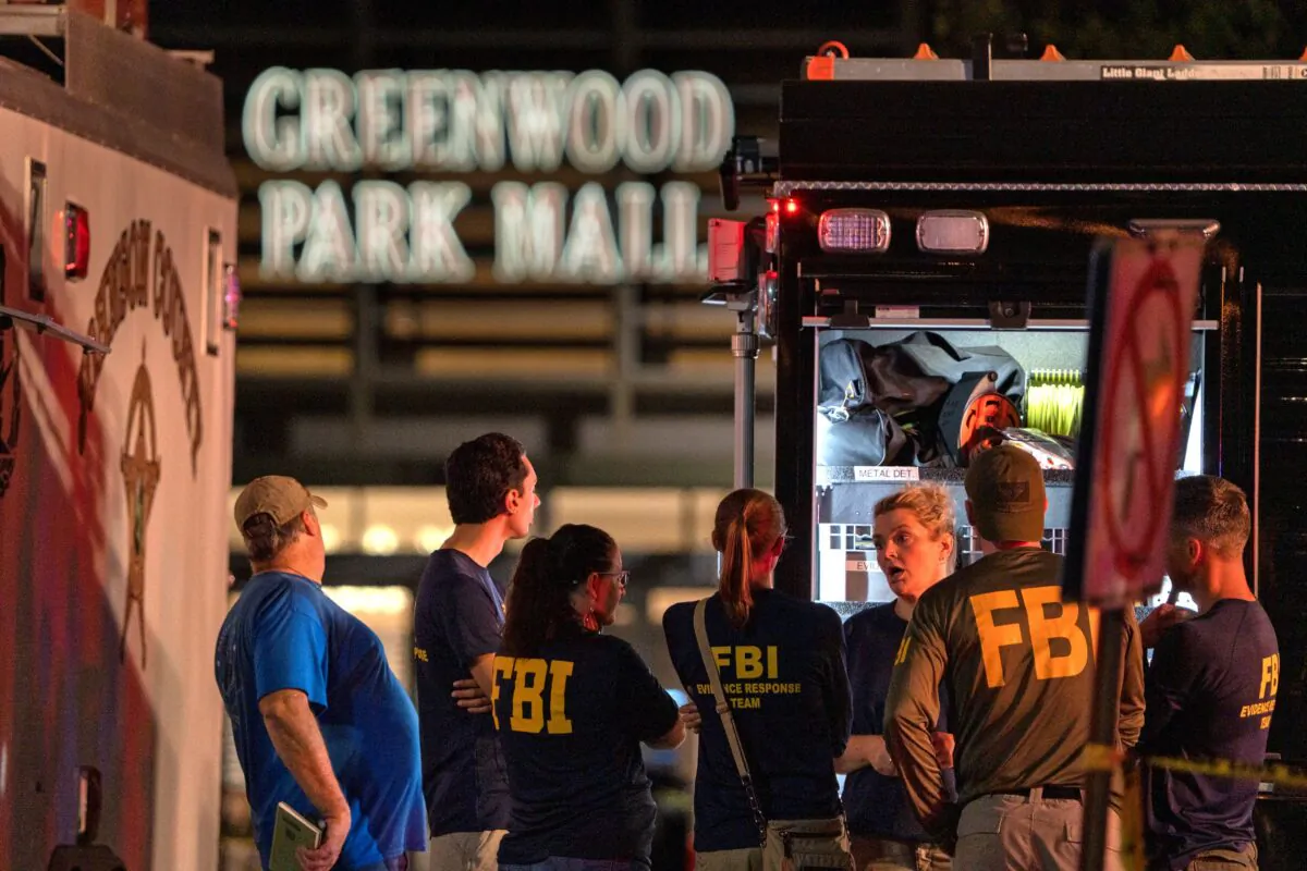 FBI agents gather at the scene of a deadly shooting at the Greenwood Park Mall in Greenwood, Ind., on July 17, 2022. (Kelly Wilkinson/The Indianapolis Star via AP)