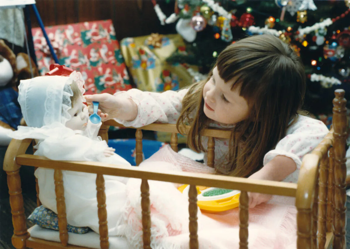 Caring for a doll is valuable developmental play and helps little girls practice caretaking. (Jena Ardell/Getty)