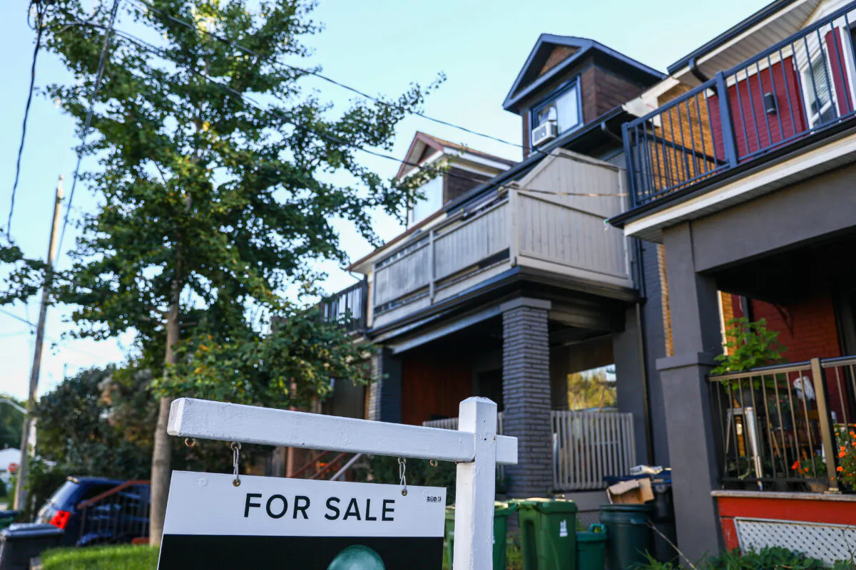 A for sale is sign is displayed in front of a house in the Riverdale area of Toronto on Sept. 29, 2021. (The Canadian Press/Evan Buhler)