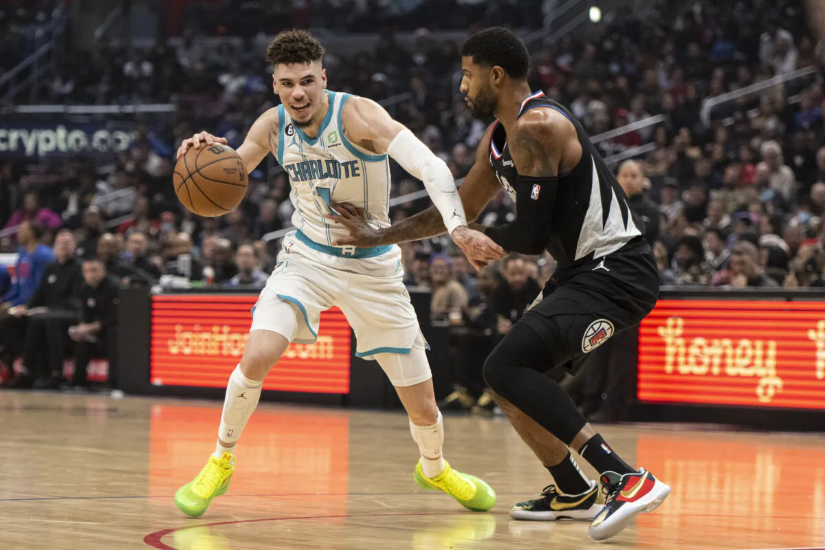 Charlotte Hornets guard LaMelo Ball (1) drives as Los Angeles Clippers guard Paul George defends during the first half of an NBA basketball game in Los Angeles on Dec. 21, 2022. (Kyusung Gong/AP Photo)