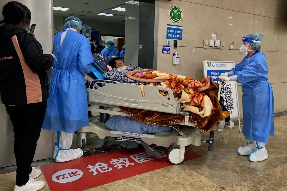 Health workers move a COVID-19 patient on a stretcher in the emergency ward of the First Affiliated Hospital of Chongqing Medical University in China's southwestern city of Chongqing on Dec. 22, 2022. (Noel Celis/AFP via Getty Images)