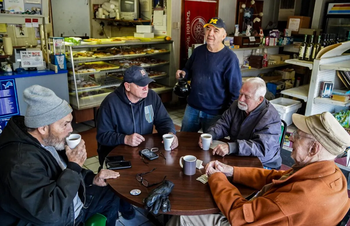 Customers discuss home heating costs at Lakeview Donut Shop in Worth, Michigan on December 20, 2022. (Steven Kovac/Epoch Times)
