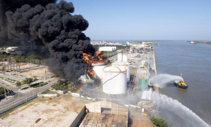 Black smoke rises during a fire in a hydrocarbon storage area of the Bravo Petroleum company in Barranquilla, Colombia, on Dec. 21, 2022. (Barranquilla City Hall Press Office/Handout via Reuters)