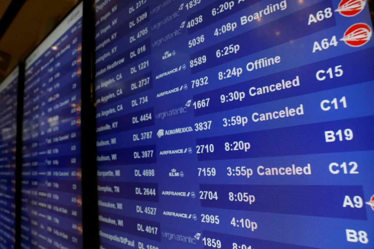 An information board shows cancelled flights at Detroit Metro Airport in Romulus, Mich., on Dec. 22, 2022. (Jeff Kowalsky/AFP via Getty Images)