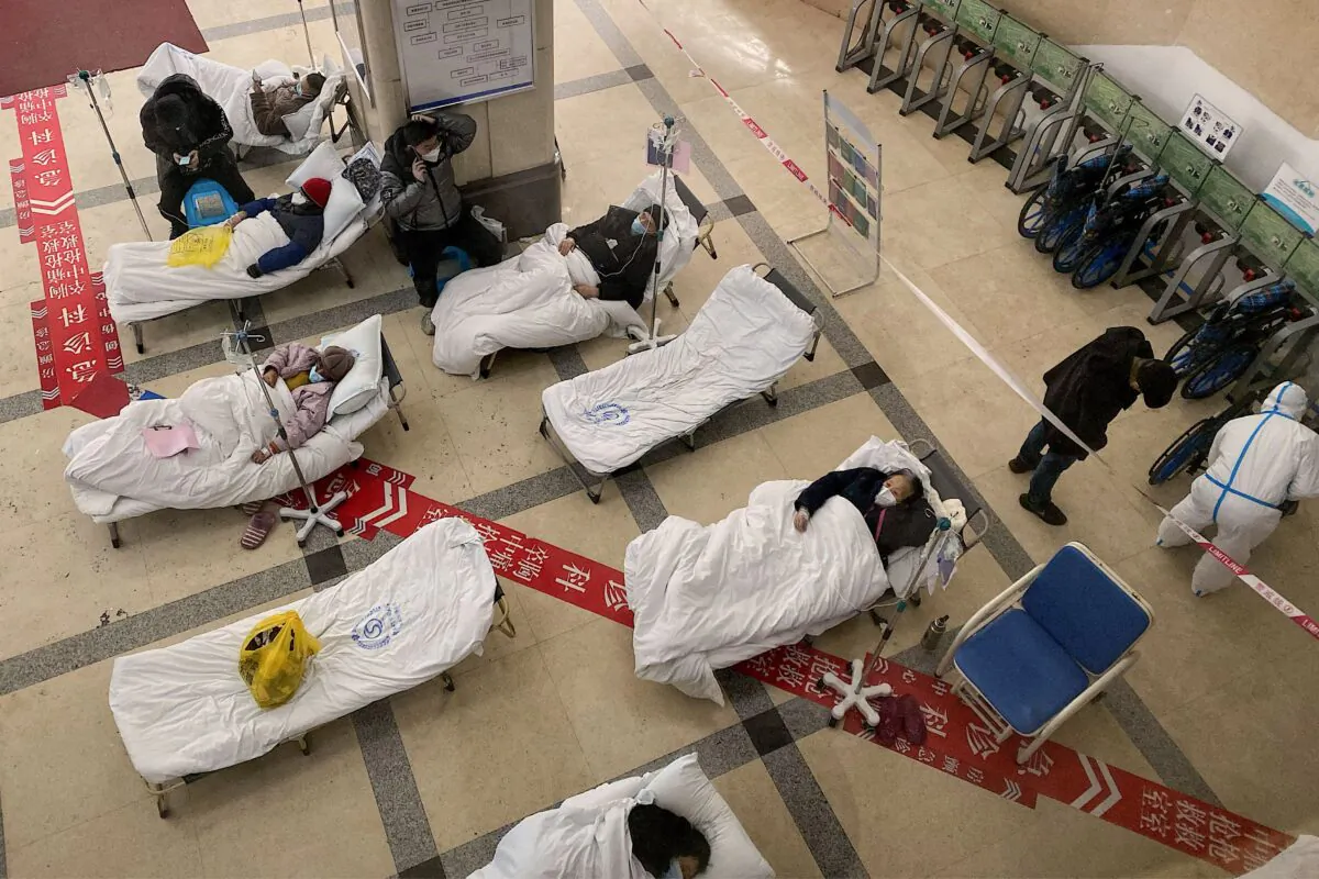 Covid-19 coronavirus patients lie on hospital beds in the lobby of the Chongqing No. 5 People's Hospital in China's southwestern city of Chongqing on Dec. 23, 2022. (Noel Celis/AFP via Getty Images)