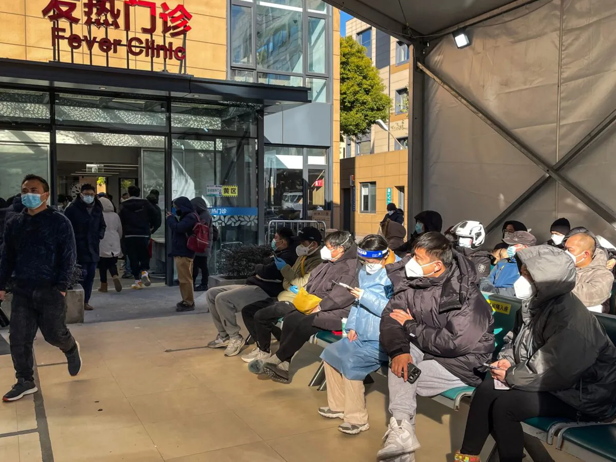 People wait for medical attention outside the Fever Clinic at Tongren Hospital in the Changning district in Shanghai, on Dec. 23, 2022. (Hector Retamal/AFP via Getty Images)