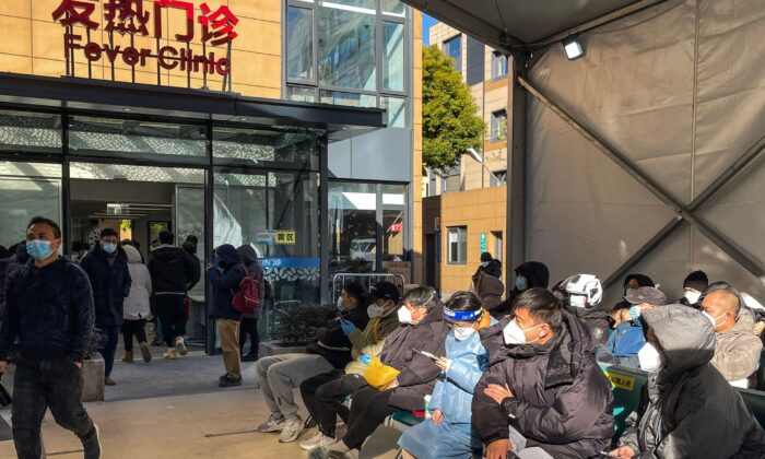 People wait for medical attention outside the Fever Clinic at  Tongren Hospital in the Changning district in Shanghai, on Dec. 23, 2022. (Hector Retamal/AFP via Getty Images)